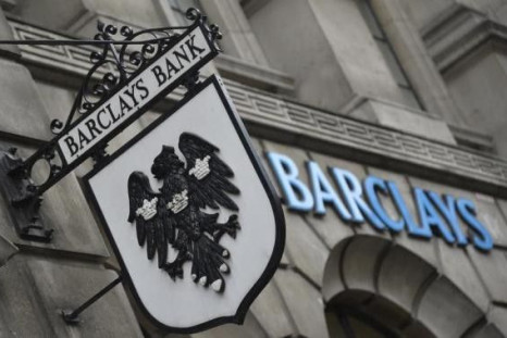 Logos are seen outside a branch of Barclays bank in London July 30, 2013.