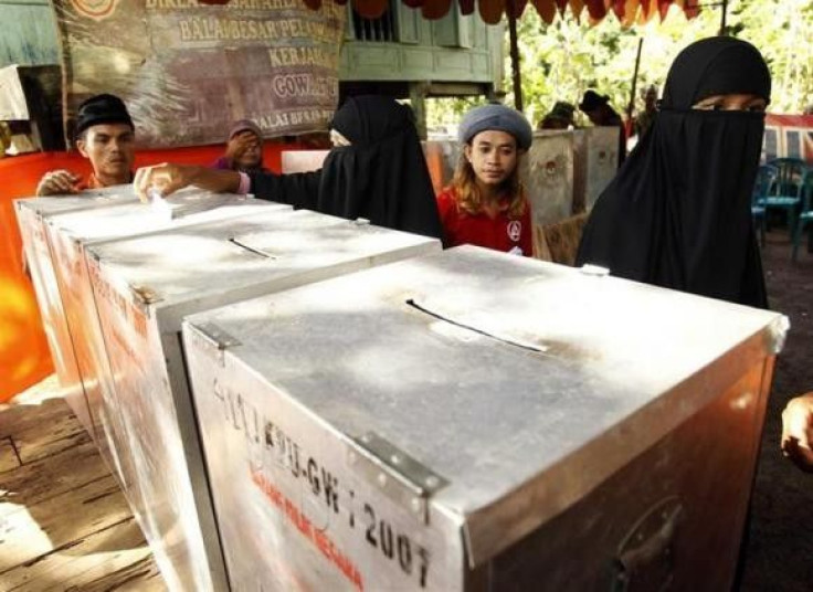 Members of an exclusive Muslim group An Nadsir cast their ballots during voting in parliamentary elections at a polling station in Gowa, South Sulawesi