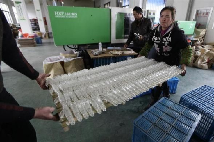 Workers carry unfinished vibrators at Ningbo Yamei plastic toy factory, on the outskirts of Fenghua, Zhejiang province, February 13, 2012.