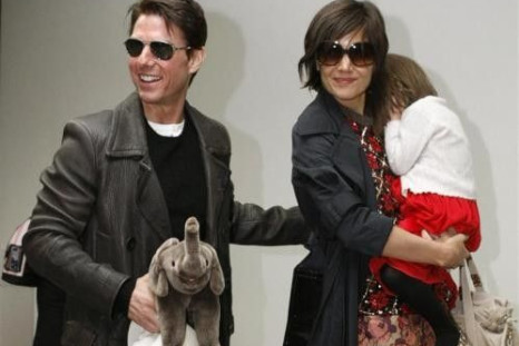 Actor Tom Cruise (L) Arrives With His Wife Katie Holmes, Who Is Holding Their Daughter Suri, At Narita International Airport