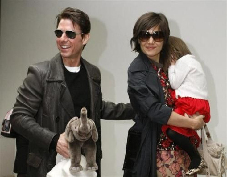 Actor Tom Cruise (L) Arrives With His Wife Katie Holmes, Who Is Holding Their Daughter Suri, At Narita International Airport