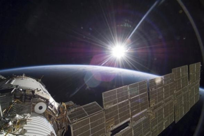 The bright sun greets the ISS in this photo taken from the Russian section of the orbital outpost by one of the STS-129 crew members November 22, 2009.