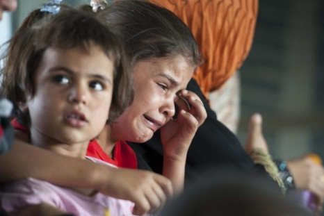 A Mother From Syria Is Crying With Her Child