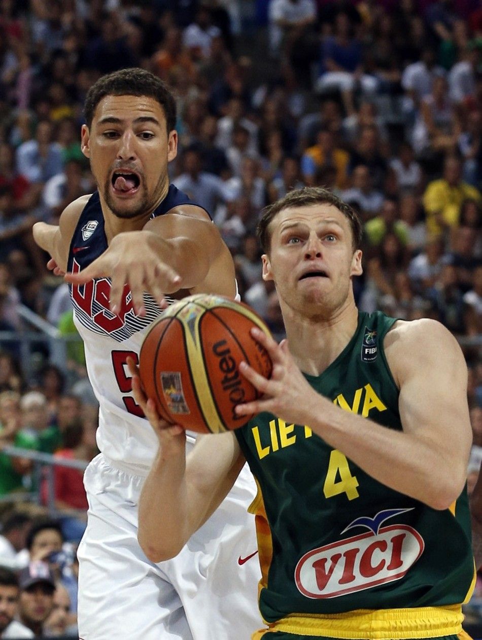 Klay Thompson of the U.S. attempts to steal the ball from Martynas Pocius of Lithuania