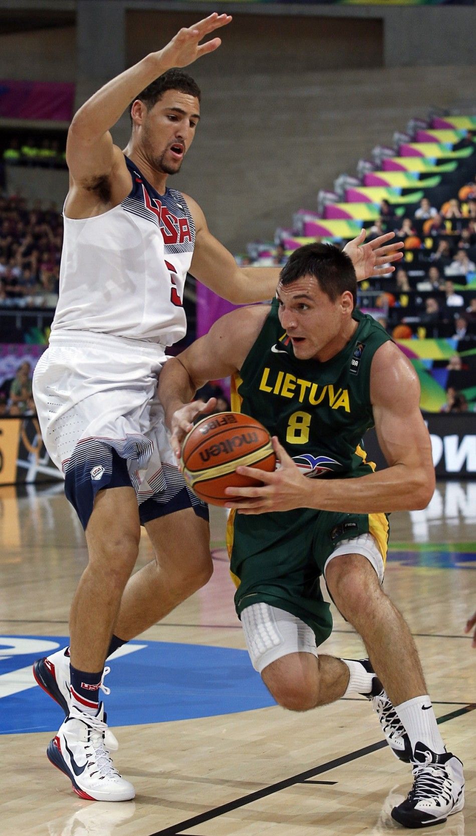 Jonas Maciulis R of Lithuania dribbles around Klay Thompson of the U.S. 