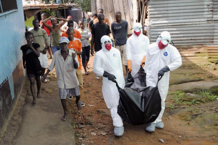 Health workers remove the body of Prince Nyentee, a 29-year-old man whom local residents said died of Ebola virus in Monrovia September 11, 2014.