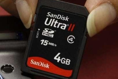 A shopper poses with a SanDisk memory card