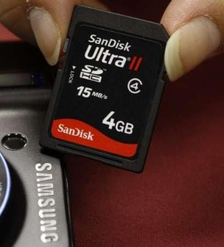 A shopper poses with a SanDisk memory card
