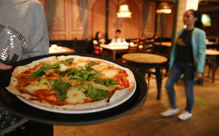 A waitress serves pizza at a restaurant in Moscow