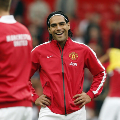 Manchester United's new signing Radamel Falcao smiles during a warm up session before their English Premier League soccer match against Queens Park Rangers at Old Trafford in Manchester, northern England September 14, 2014.