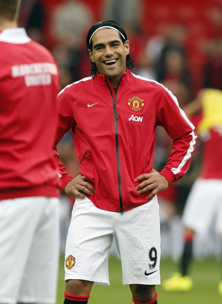 Manchester United's new signing Radamel Falcao smiles during a warm up session before their English Premier League soccer match against Queens Park Rangers at Old Trafford in Manchester, northern England September 14, 2014.