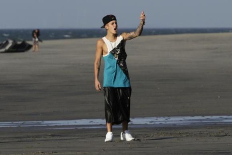 Canadian pop singer Justin Bieber gestures at a beach as he takes a break in a resort in Punta Chame, on the outskirts of Panama City
