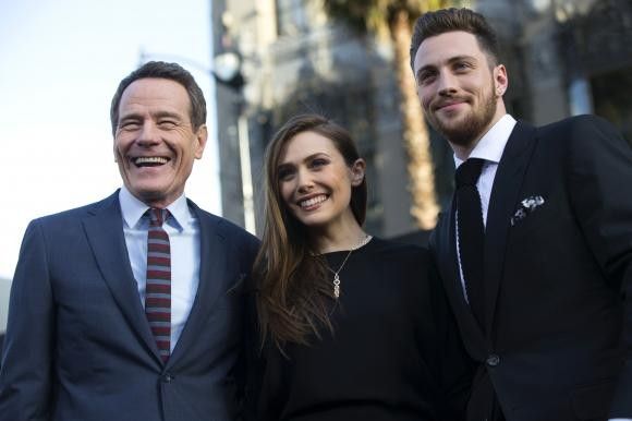 Cast members Bryan Cranston L, Elizabeth Olsen C and Aaron Taylor-Johnson pose at the premiere of 039039Godzilla039039 at the Dolby theatre in Hollywood, California