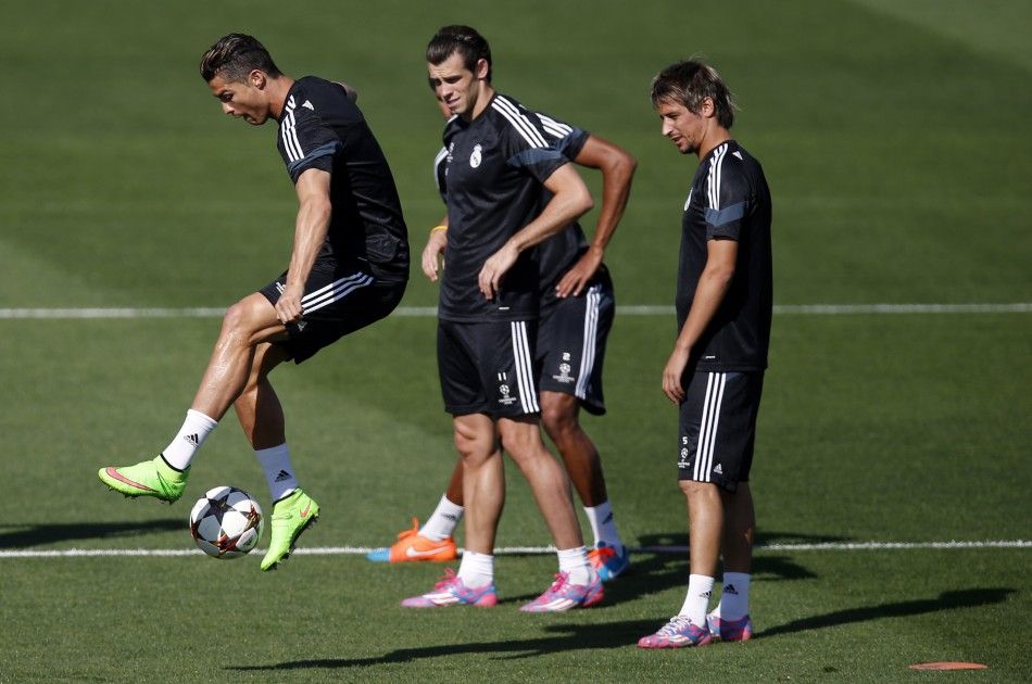 Real Madrid039s Cristiano Ronaldo L controls the ball next to teammates Gareth Bale C and Fabio Coentrao during their training session on the eve of their Champions League match against Basel at Valdebebas training grounds in Madrid September 15, 2