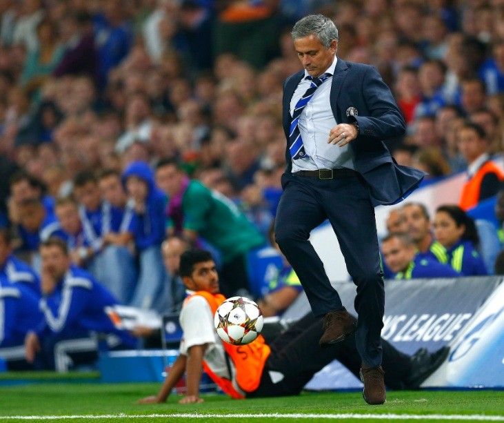 Chelsea manager Jose Mourinho kicks the match ball during their Champions League soccer match against Schalke 04 at Stamford Bridge in London September 17, 2014. 