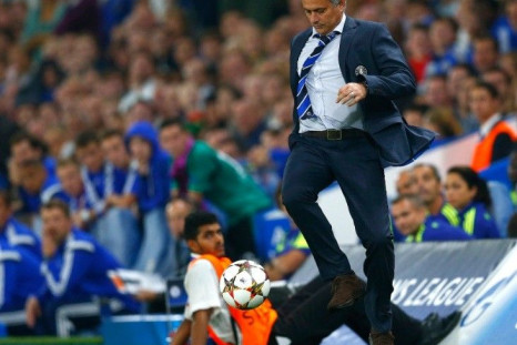 Chelsea manager Jose Mourinho kicks the match ball during their Champions League soccer match against Schalke 04 at Stamford Bridge in London September 17, 2014. 