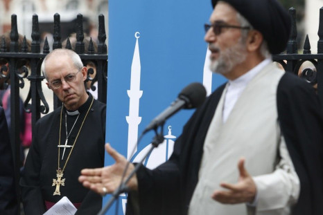 The Archbishop of Canterbury Justin Welby (L) listens to Ayatollah Sayed Fazel Milani during a vigil outside Westminster Abbey in central London September 3, 2014.
