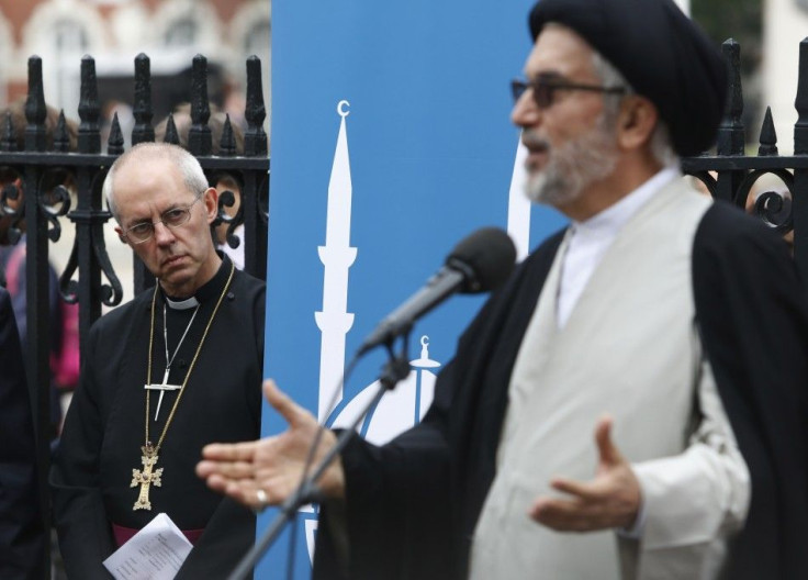 The Archbishop of Canterbury Justin Welby (L) listens to Ayatollah Sayed Fazel Milani during a vigil outside Westminster Abbey in central London September 3, 2014.