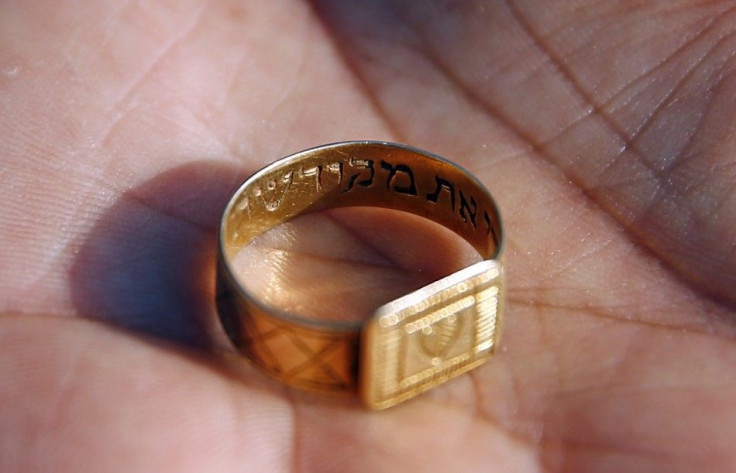 A golden ring inscriptioned in Hebrew is shown after being discovered in the perimeter of a Nazi death camp in Sobibor September 18, 2014.
