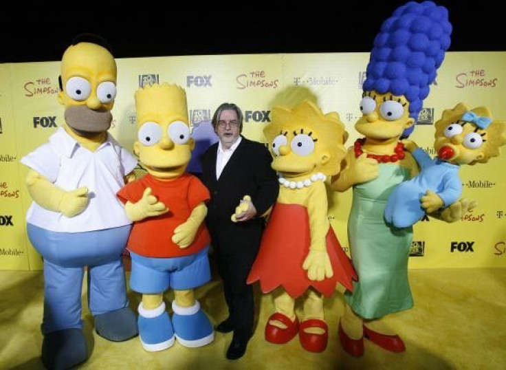 Matt Groening (C), creator of The Simpsons, poses with characters from the show