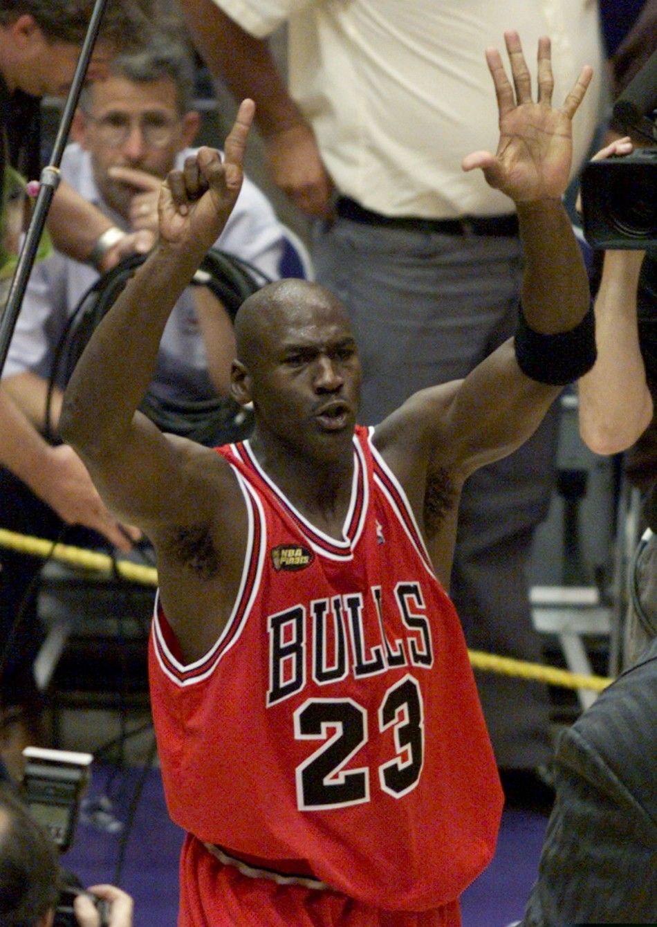 Chicago Bulls Michael Jordan holds up six fingers as he walks around the court after the Bulls defeated the Utah Jazz 87-86 to win the NBA championship in Salt lake City June 14, 1998. Jordan won his 6th NBA title and was named the series MVP.