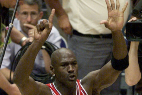 Chicago Bulls Michael Jordan holds up six fingers as he walks around the court after the Bulls defeated the Utah Jazz 87-86 to win the NBA championship in Salt lake City June 14, 1998. Jordan won his 6th NBA title and was named the series MVP.