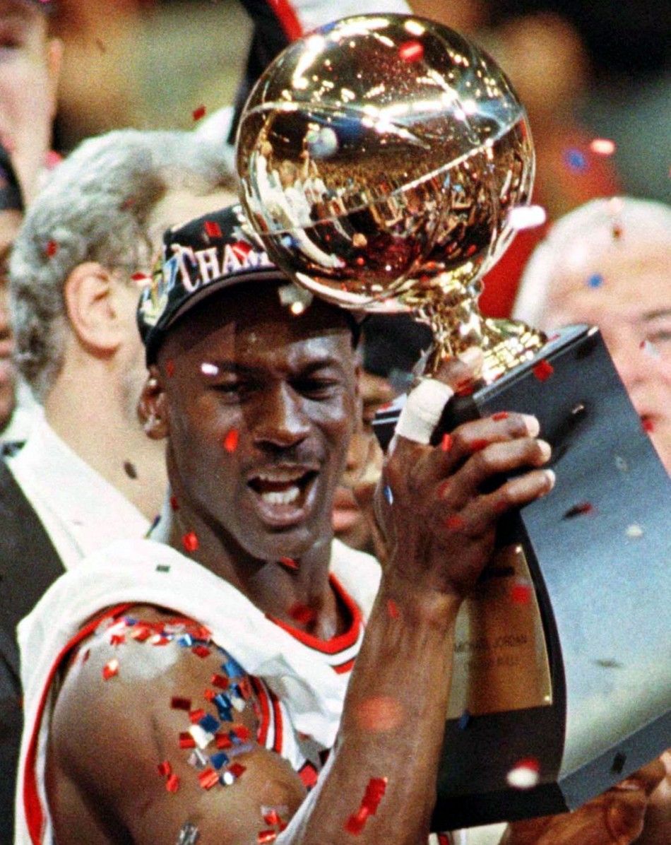 Chicago Bulls guard Michael Jordan holds the NBA championship trophy after the Bulls beat the Utah Jazz 90-86 in game six of the NBA Finals in Chicago, June 13, 1997. Jordan, considered the greatest basketball player of all time, will announce his retirem