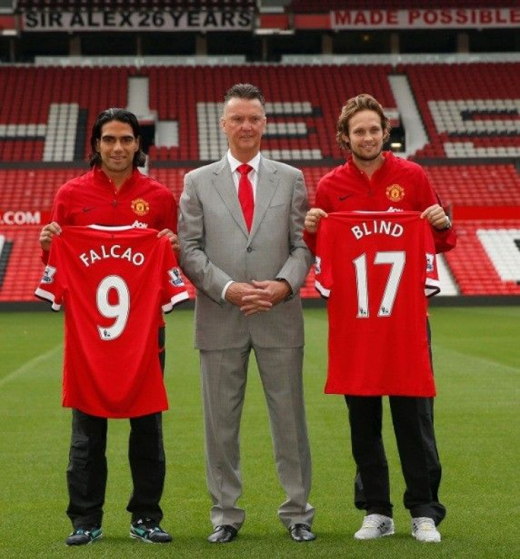New Manchester United signings Radamel Falcao (L) and Daley Blind (R) pose with manager Louis Van Gaal during a photocall at Old Trafford in Manchester, northern England September 11, 2014.