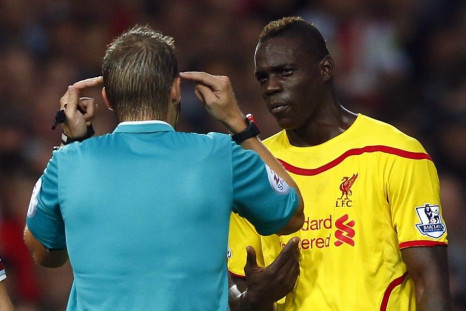 Liverpool's Mario Balotelli (R) is spoken to by match referee Craig Pawson during their English Premier League soccer match against West Ham United at the Boleyn Ground in London September 20, 2014.