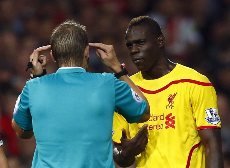 Liverpool's Mario Balotelli (R) is spoken to by match referee Craig Pawson during their English Premier League soccer match against West Ham United at the Boleyn Ground in London September 20, 2014.