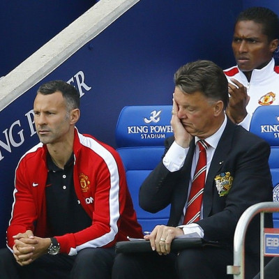 Manchester United manager Louis Van Gaal (R) and his assistant Ryan Giggs react during their English Premier League soccer match against Leicester City at the King Power stadium in Leicester, northern England September 21, 2014.