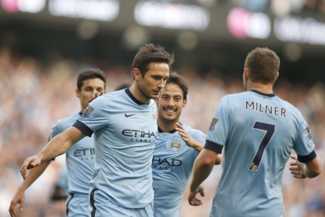 Manchester City's players run towards Frank Lampard (C) after he scored a goal against Chelsea during their English Premier League soccer match at the Etihad stadium in Manchester, northern England September 21, 2014.