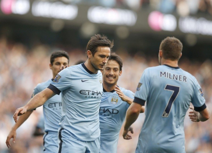 Manchester City's players run towards Frank Lampard (C) after he scored a goal against Chelsea during their English Premier League soccer match at the Etihad stadium in Manchester, northern England September 21, 2014.