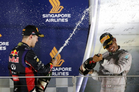 Lewis Hamilton and Sebastien Vettel celebrate at the podium after Singapore F1 Grand Prix