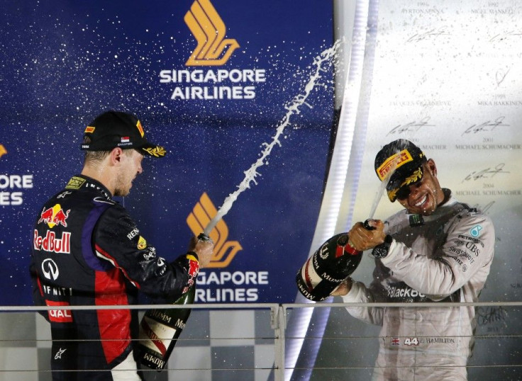 Lewis Hamilton and Sebastien Vettel celebrate at the podium after Singapore F1 Grand Prix