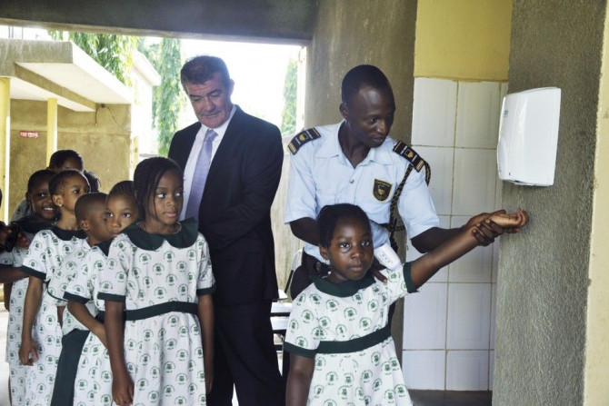 Olumawu School Pupils Are Guided Through The Use Of Hand Sanitizers