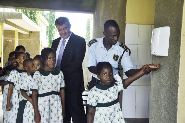 Olumawu School Pupils Are Guided Through The Use Of Hand Sanitizers