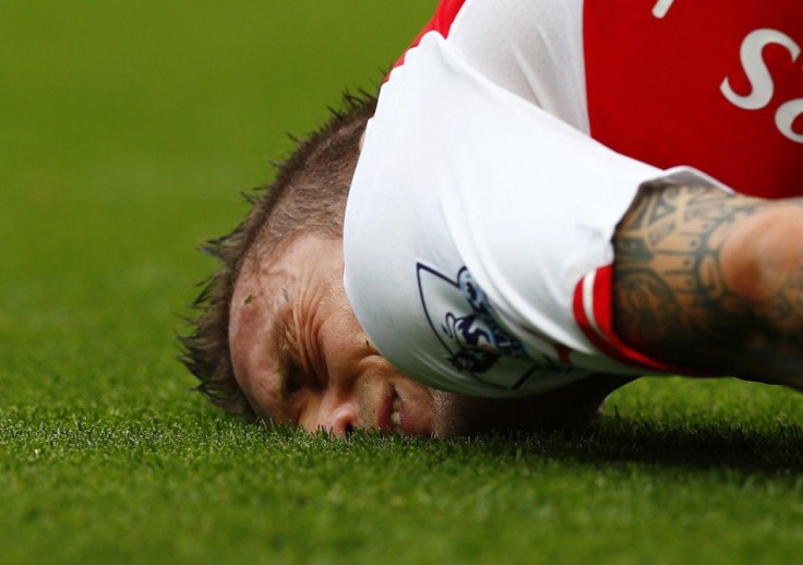 Arsenal&#039;s Mathieu Debuchy reacts after being fouled during their English Premier League soccer match against Manchester City at the Emirates stadium in London September 13, 2014.