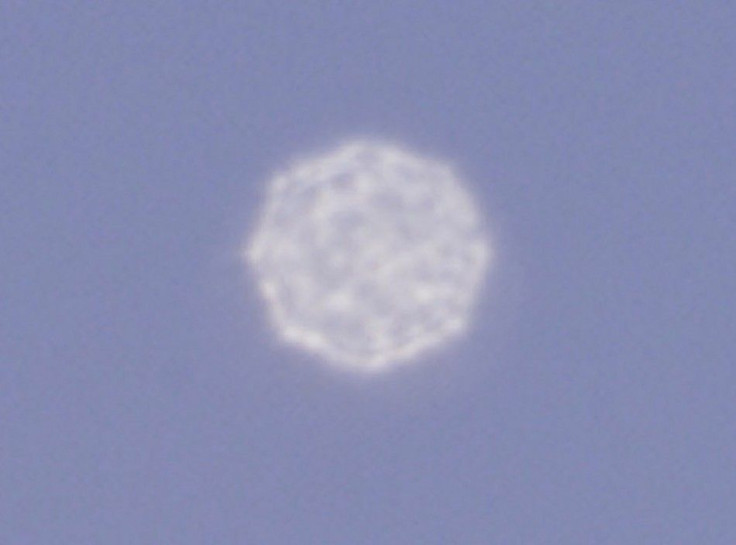 An Unidentified Object Flies Over Mexico City, Seen Through A Very Long Telephoto Lens