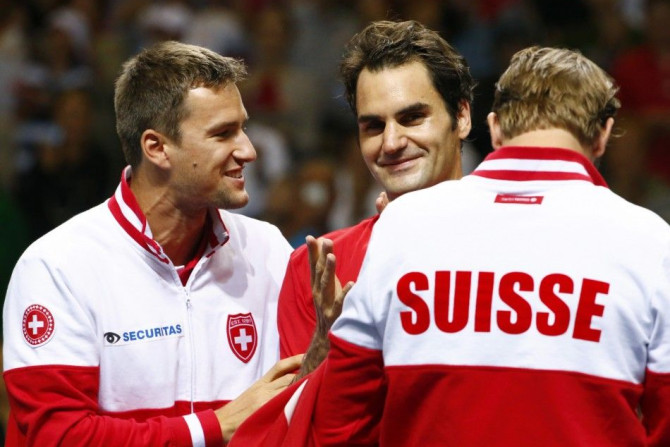 Switzerland&#039;s Roger Federer celebrates with Marco Chiudinell and Michael Lammer