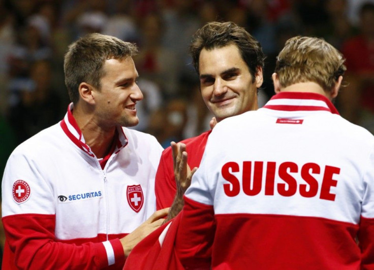 Switzerland&#039;s Roger Federer celebrates with Marco Chiudinell and Michael Lammer