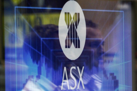 Office workers are reflected as they walk past the Australian Securities Exchange building in central Sydney April 8, 2011. Singapore Exchange Ltd has terminated its $8 billion bid for Australia's ASX Ltd after the Australian government formally rejected 