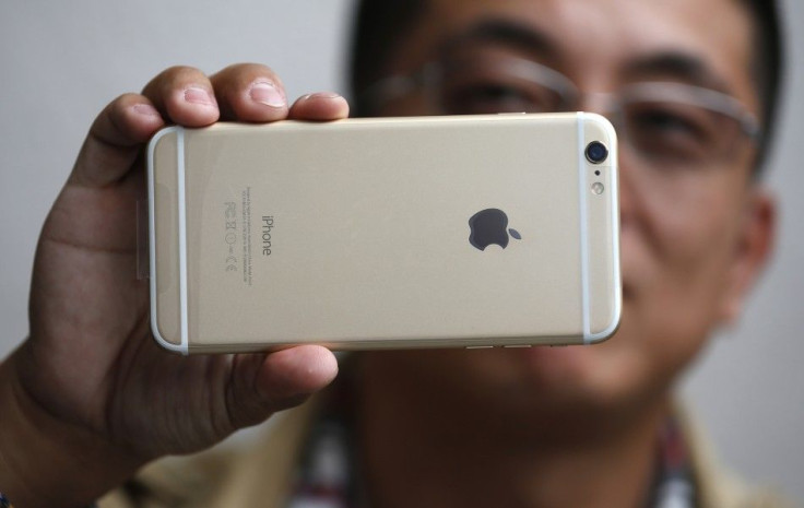 Tony Zhan, 32, holds up his new iPhone 6 Plus after it went on sale at the Apple store in Pasadena, California September 19, 2014. Hundreds of customers waited in lines outside the store on the first day the new iPhone became available.