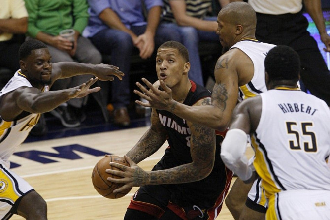 May 28, 2014; Indianapolis, IN, USA; Miami Heat forward Michael Beasley (8) goes up for a shot while being guarded by Indiana Pacers forward David West (21) during the fourth quarter in game five of the Eastern Conference Finals of the 2014 NBA Playoffs a