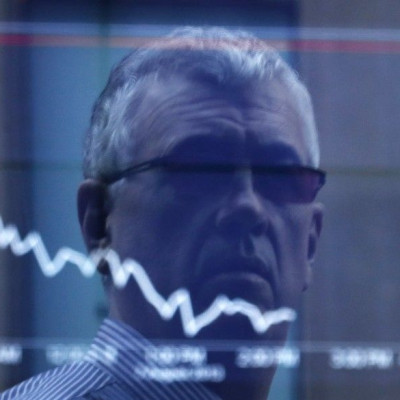 An office worker is reflected in the window of the Australian Securities Exchange building displaying the ASX50 curve for Wednesday in central Sydney August 7, 2013. Australian shares skidded 1.3 percent on Wednesday, its biggest fall in five weeks, hit b