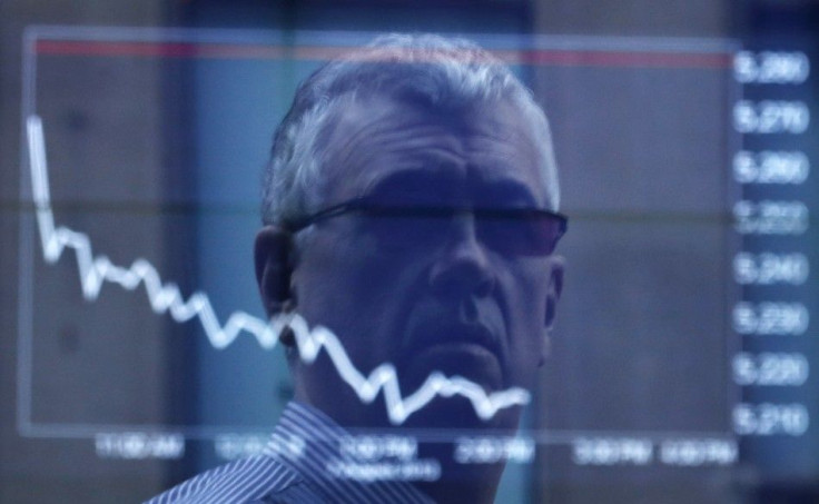 An office worker is reflected in the window of the Australian Securities Exchange building displaying the ASX50 curve for Wednesday in central Sydney August 7, 2013. Australian shares skidded 1.3 percent on Wednesday, its biggest fall in five weeks, hit b
