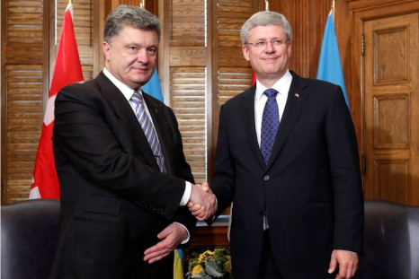 anada's Prime Minister Stephen Harper (R) shakes hands with Ukraine's President Petro Poroshenko