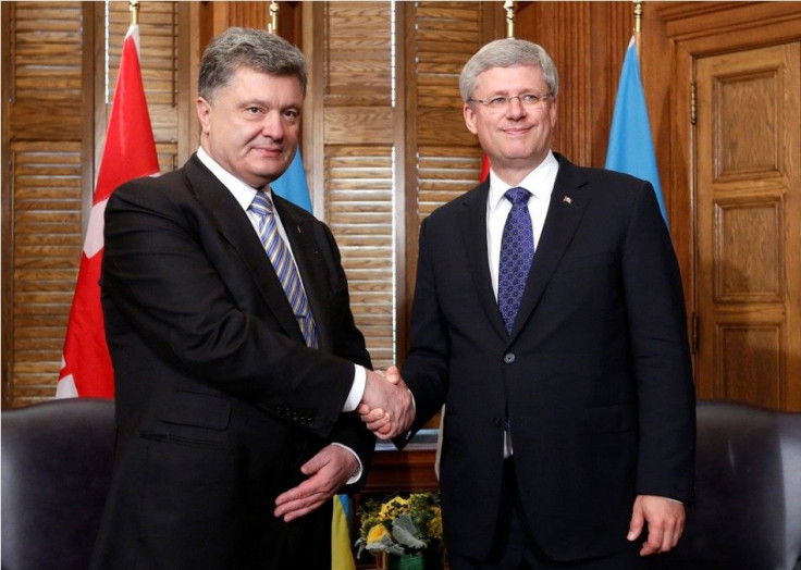 anada's Prime Minister Stephen Harper (R) shakes hands with Ukraine's President Petro Poroshenko