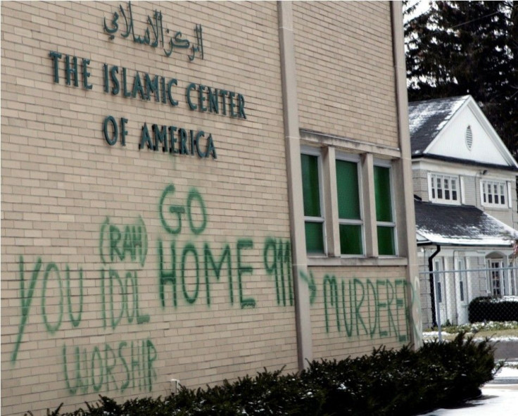 Anti-Muslim graffiti is seen painted on the wall