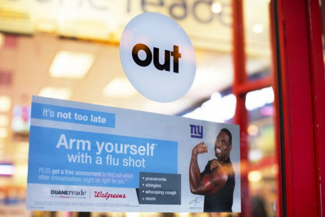 A sign advertising the availability of flu shots is taped onto a door of a Duane Reade in New York, January 14, 2013. Influenza has officially reached epidemic proportions in the United States, with 7.3 percent of deaths last week caused by pneumonia and 